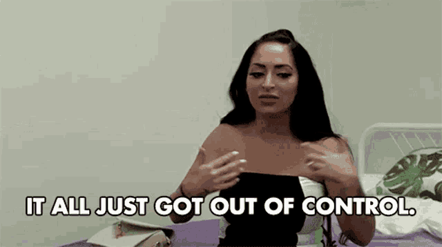 a woman is sitting on a bed and talking about getting out of control .