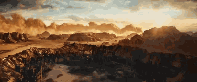 an aerial view of a desert landscape with mountains in the background