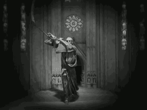 a black and white photo of a skeleton holding a sword in front of a building .
