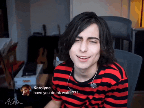 a man in a red and black striped shirt is asking karolyne if he is drunk