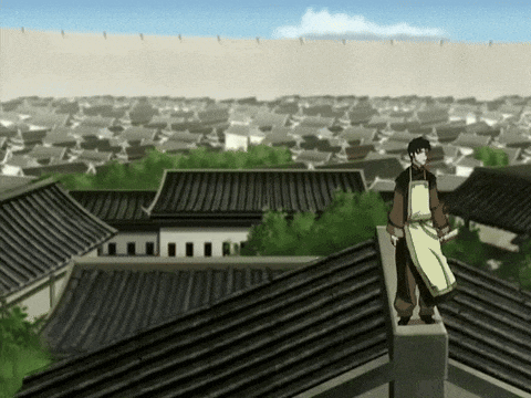 a man in an apron is standing on the edge of a roof overlooking a city .