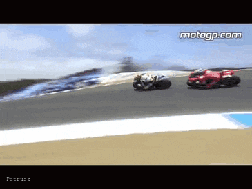 two motorcycle racers are racing on a track and the website motogp.com is visible