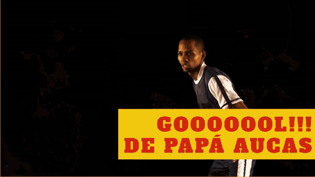 a soccer player stands in front of a yellow sign that says goooool !!!