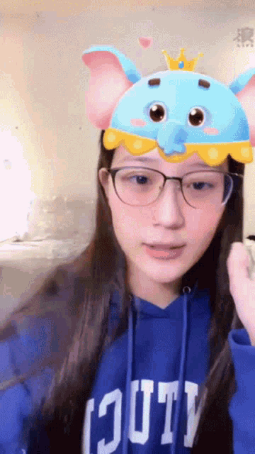 a girl wearing glasses and a blue hoodie that says youth