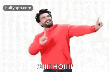 a man in a red sweater is giving a thumbs up and dancing .