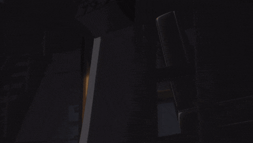 a dark room with a light coming out of the door