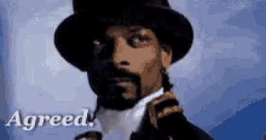 snoop dogg is wearing a top hat and tie with the words agreed below him