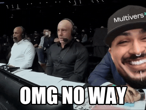 a man wearing a hat that says multiverse is smiling and says omg no way