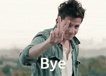 a young man in a denim shirt is giving a peace sign and saying bye .