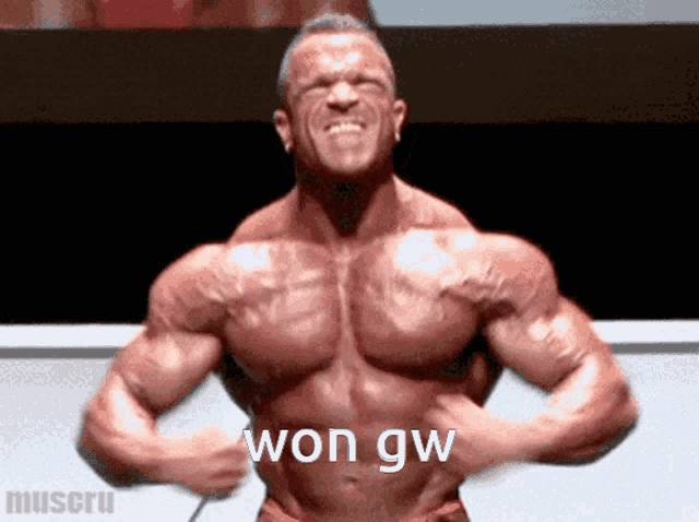 a bodybuilder flexing his muscles with the words won gw written on his chest