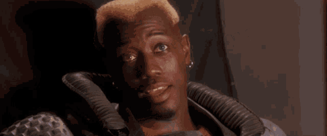a man with blonde hair and the words exactamundo on the bottom