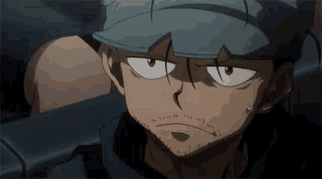 a close up of a man with a beard wearing a hat and looking at the camera .