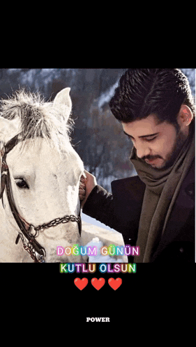 a man petting a white horse with the words dogum gunun kutlu olsun in the corner