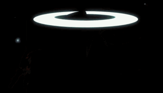 a person 's hand is holding a glowing light ring