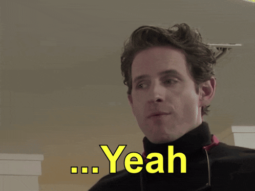 a man wearing a black turtleneck sweater says yeah