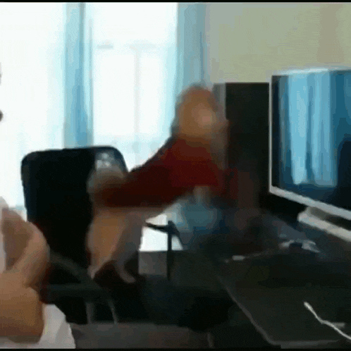 a dog is standing on its hind legs in front of a computer screen