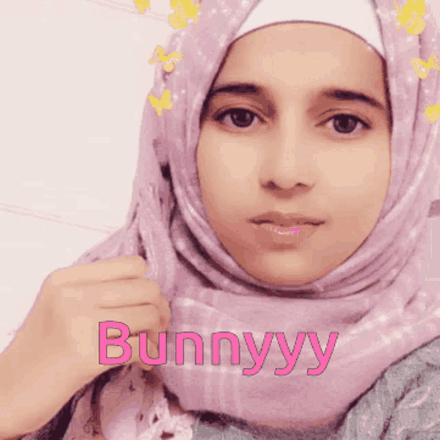 a woman wearing a purple scarf with the word bunnyyy written on it