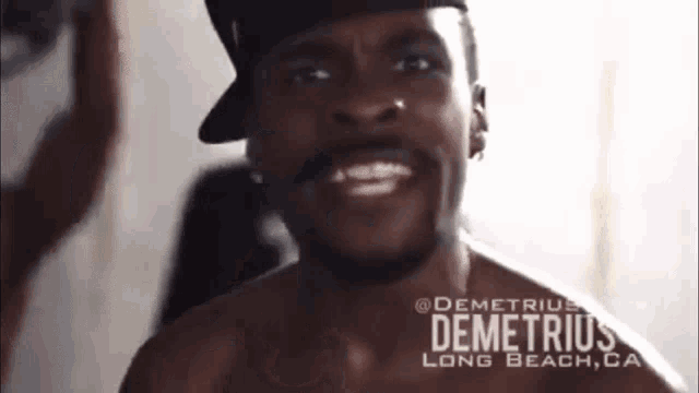 a shirtless man with the name demetrius long beach ca on his chest
