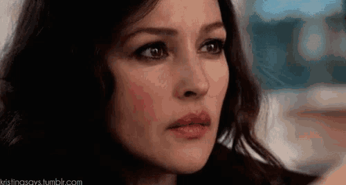 a close up of a woman 's face with a tear coming out of her eyes .