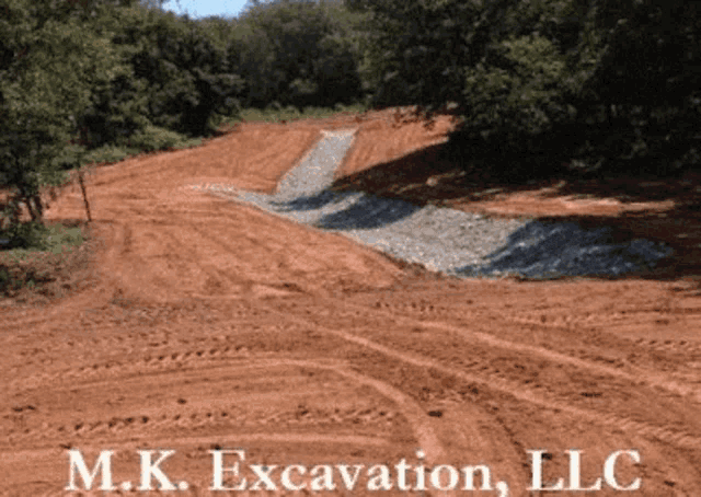 a dirt road with the words mk excavation llc written on the bottom