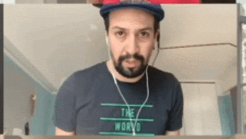 a man wearing a hat and a t-shirt that says " the world "