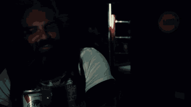 a man with dreadlocks and a beard is smiling