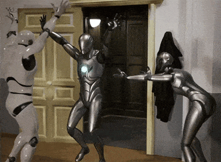 a group of robots are dancing in a room and one of them is wearing a iron man suit