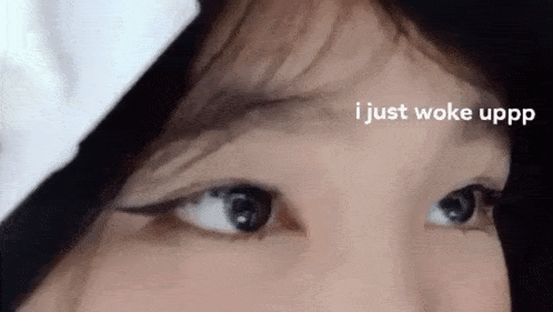 a close up of a woman 's eyes with the words `` i just woke uppp '' written above her .