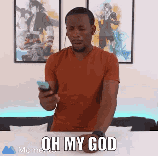 a man holding a cell phone with the words oh my god on the bottom