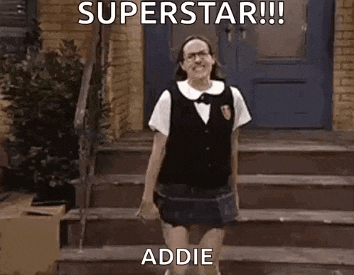 a woman in a school uniform is standing on a set of stairs in front of a blue door .