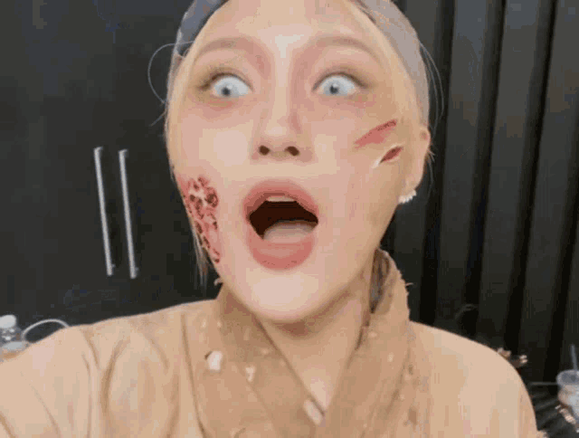 a woman with a scar on her face is making a surprised face