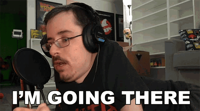 a man wearing headphones says " i 'm going there " in front of a microphone