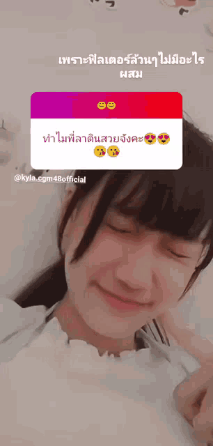a girl with her eyes closed has a sticker on her face that says kyla.cgm48official