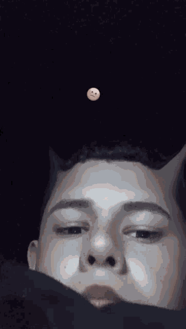 a man with horns on his head has a smiley face on his head