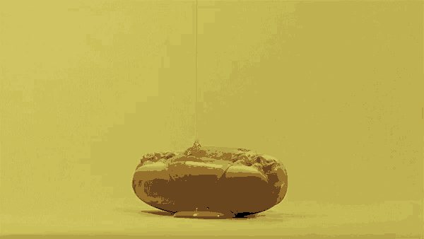 a hot dog with peanut butter and mustard on it