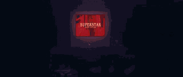 a dark room with a tv screen that says superstar danileigh on it
