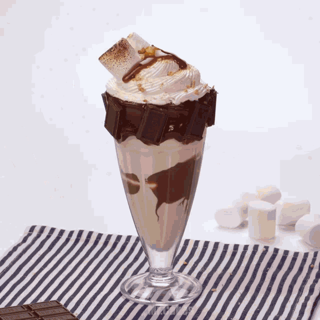 a milkshake with a s'mores topping and chocolate bars