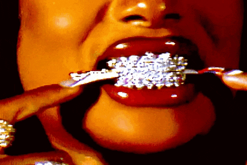 a close up of a woman 's mouth with a ring on her teeth
