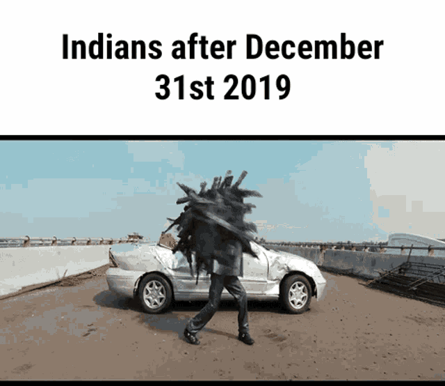 a picture of a man carrying a pile of sticks next to a car with the caption indians after december 31st 2019