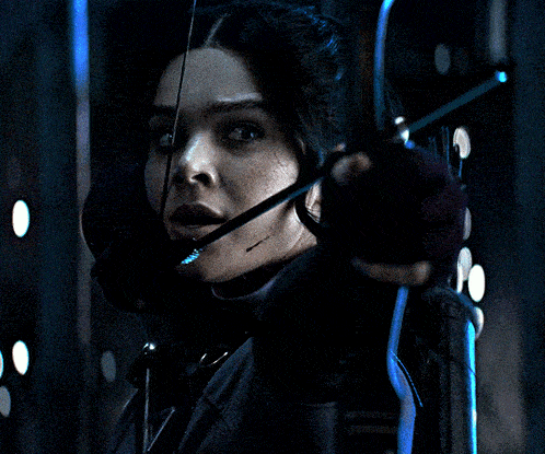 a woman holding a bow and arrow in her hand