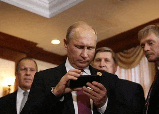 a man in a suit is looking at his phone