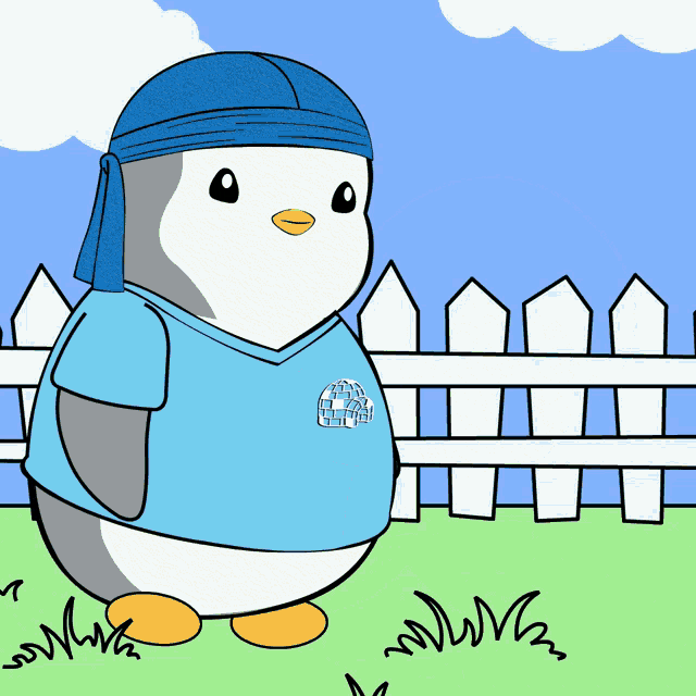a cartoon of a penguin wearing a blue shirt with an igloo on the front