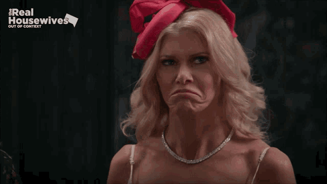 a woman wearing a red hat with the words real housewives out of context below her