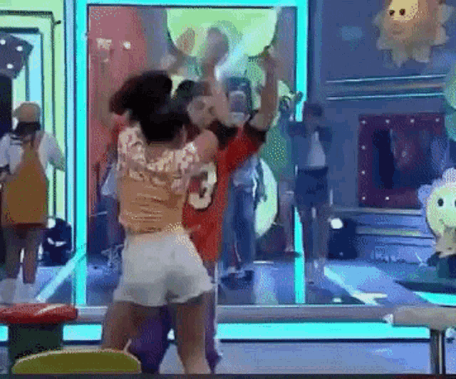a group of people are dancing in front of a mirror with one wearing a number 3 shirt