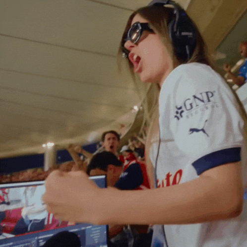 a woman wearing headphones and a gnp shirt