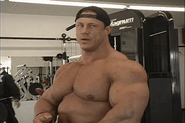 a man standing in front of a machine that says magnum 2001