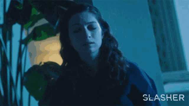 a woman is saying oh my god in a dark room
