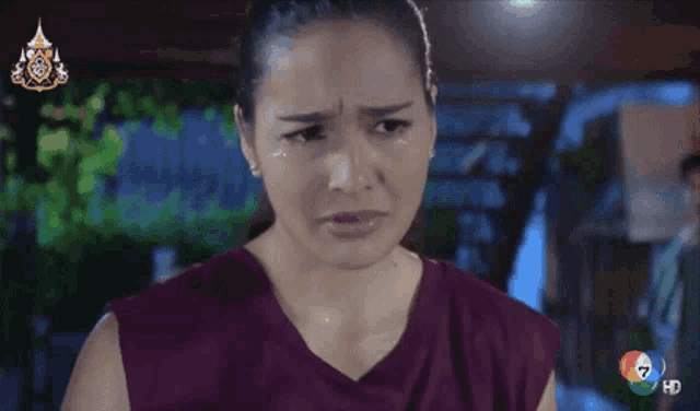 a woman with tears running down her face is on a tv screen with the number 7 on it