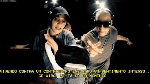 two men are standing next to each other and one of them is wearing headphones and sunglasses