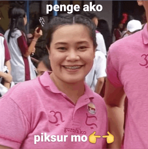 a woman wearing a pink shirt that says guro/ako on it